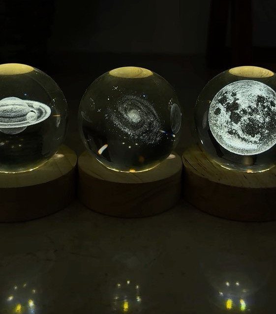 29 Trendy Gift Ideas for Her: The 2026 Gift Guide 20 Three glowing glass spheres with 3D celestial etchings on wooden bases.
