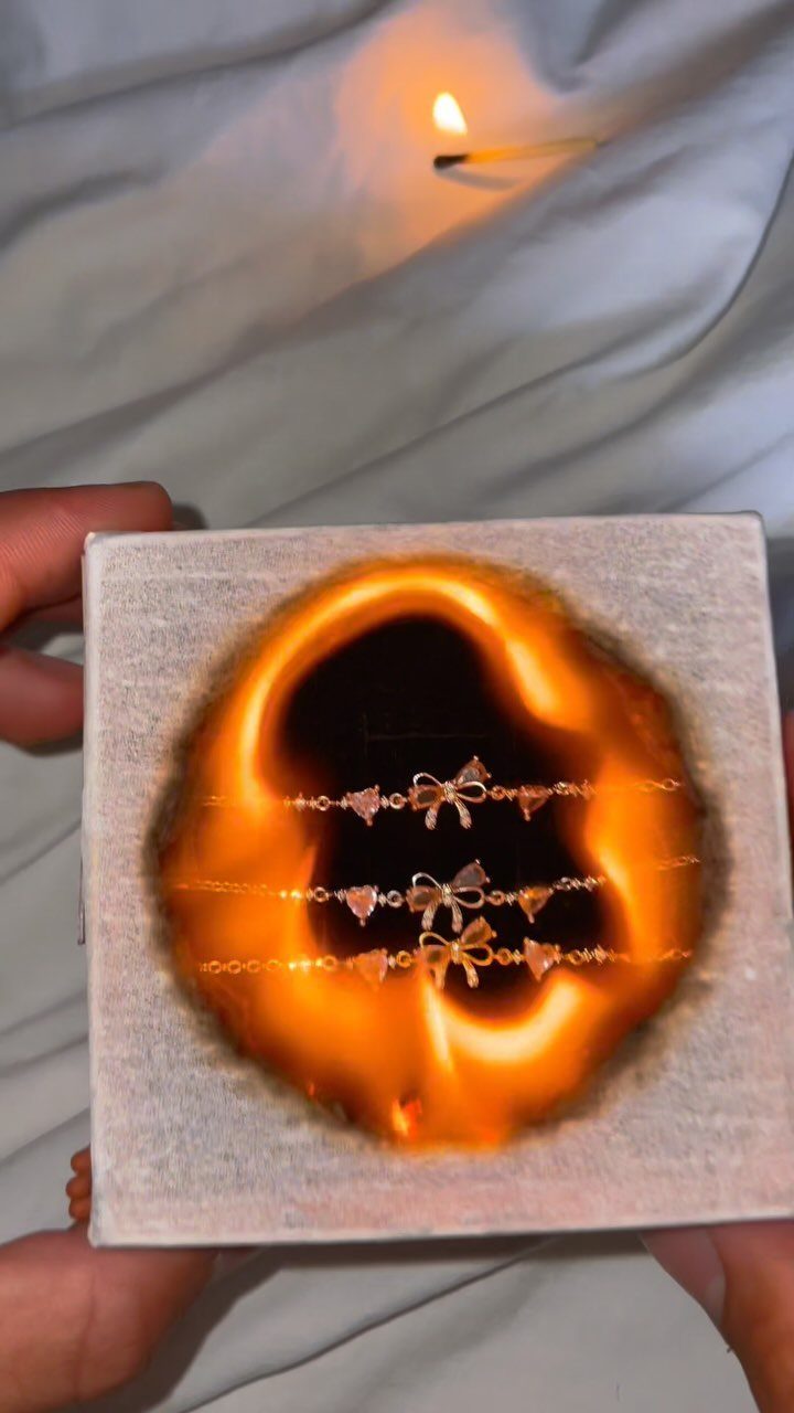 29 Trendy Gift Ideas for Her: The 2026 Gift Guide 23 Gold bow bracelets displayed inside a burnt circular hole in a white box.