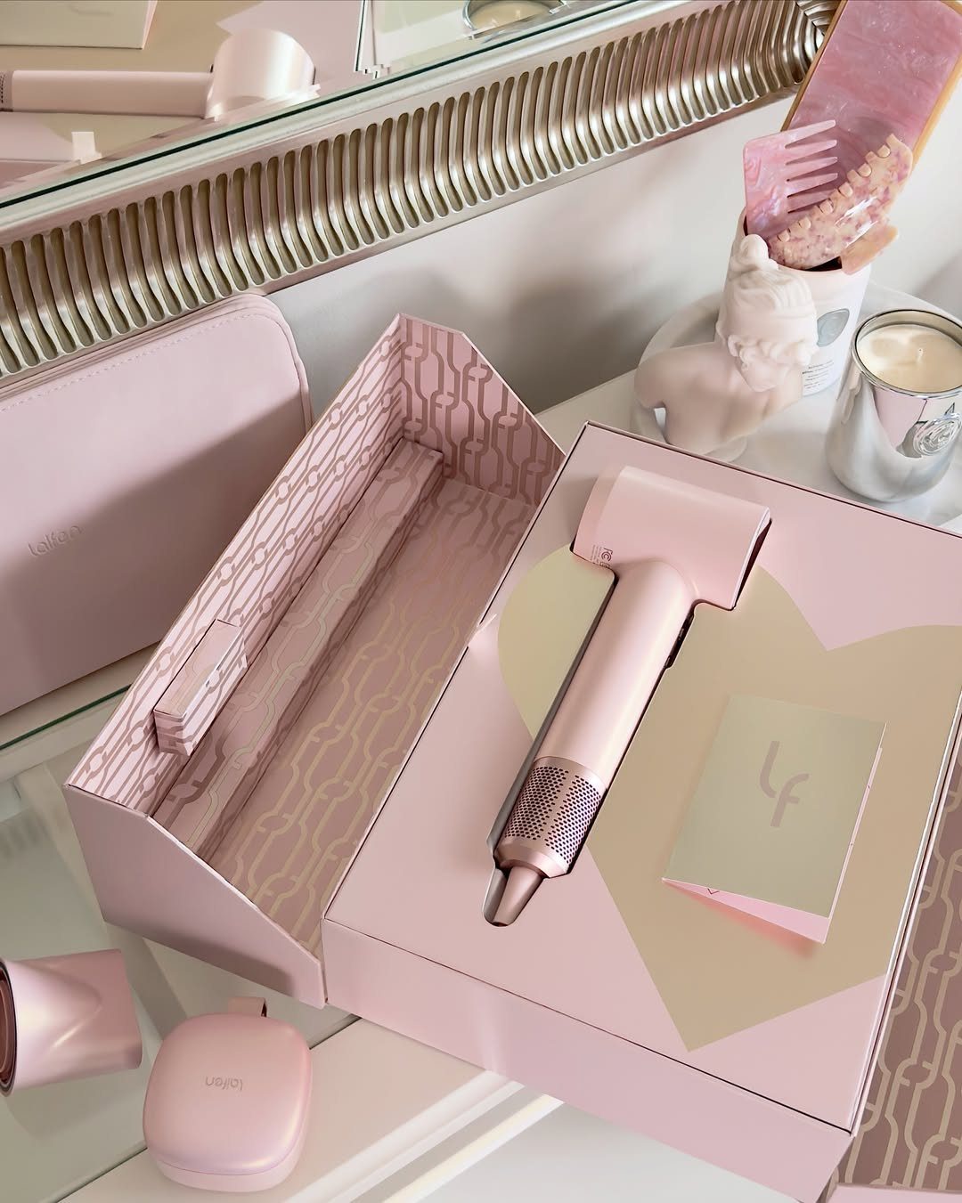 29 Trendy Gift Ideas for Her: The 2026 Gift Guide 19 Pink hair styling tool in a heart-themed gift box on a white counter.