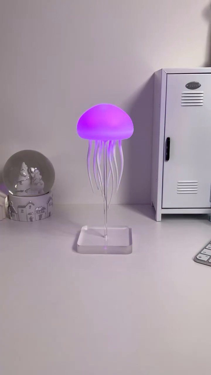 29 Trendy Gift Ideas for Her: The 2026 Gift Guide 22 Purple glowing jellyfish lamp on a white desk next to a small locker