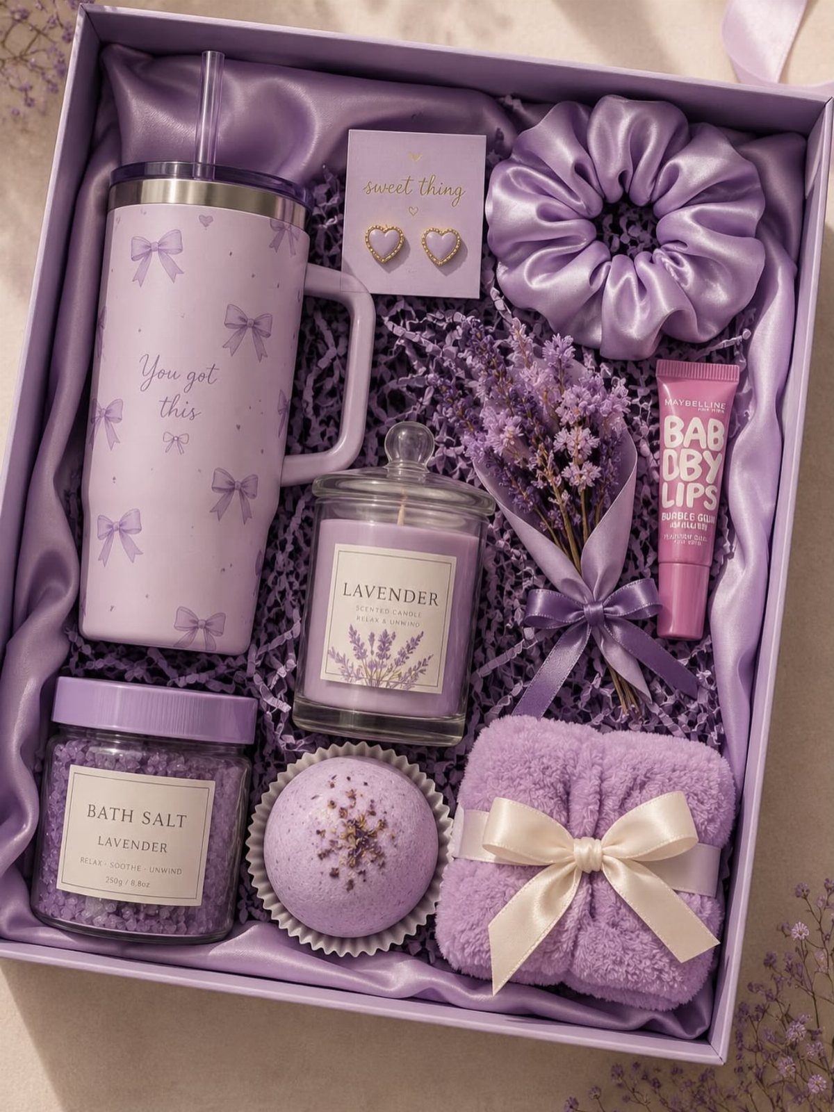29 Trendy Gift Ideas for Her: The 2026 Gift Guide 16 Purple gift box with lavender-scented spa products, a tumbler, and a satin scrunchie.