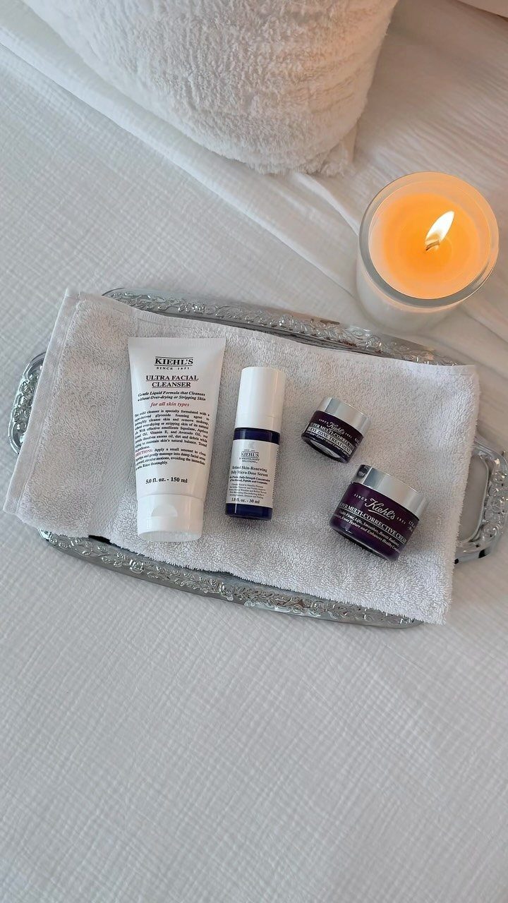 29 Trendy Gift Ideas for Her: The 2026 Gift Guide 29 Skincare gift set on a silver tray with a lit candle nearby.