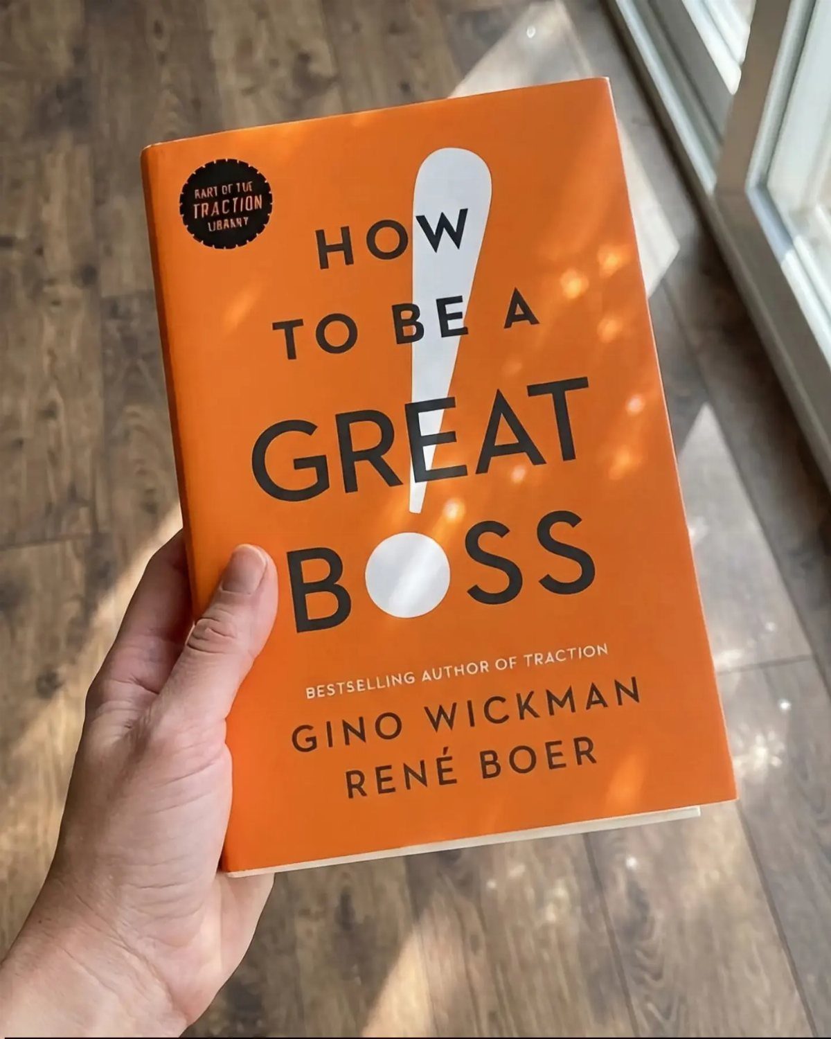 9 Unique Gift for Boss 8 Orange book titled How to Be a Great Boss held by a hand.