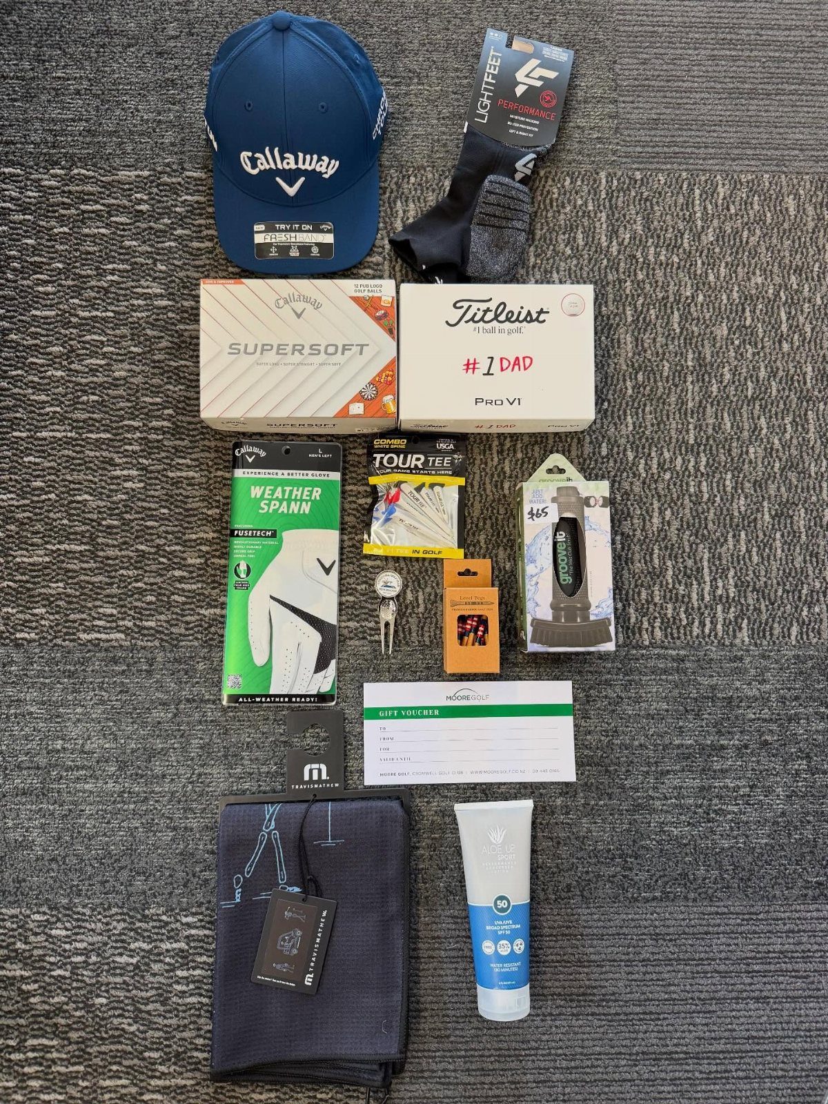 12 Useful Gifts for Dad: Practical Picks He'll Actually Use 1 Golf accessories including a blue hat, golf balls, and gear arranged on grey carpet.