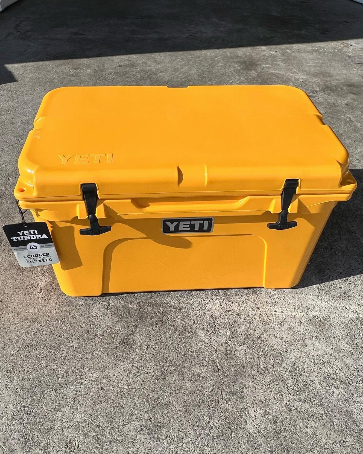12 Useful Gifts for Dad: Practical Picks He'll Actually Use 8 Yellow Yeti Tundra cooler with black latches on a grey concrete floor