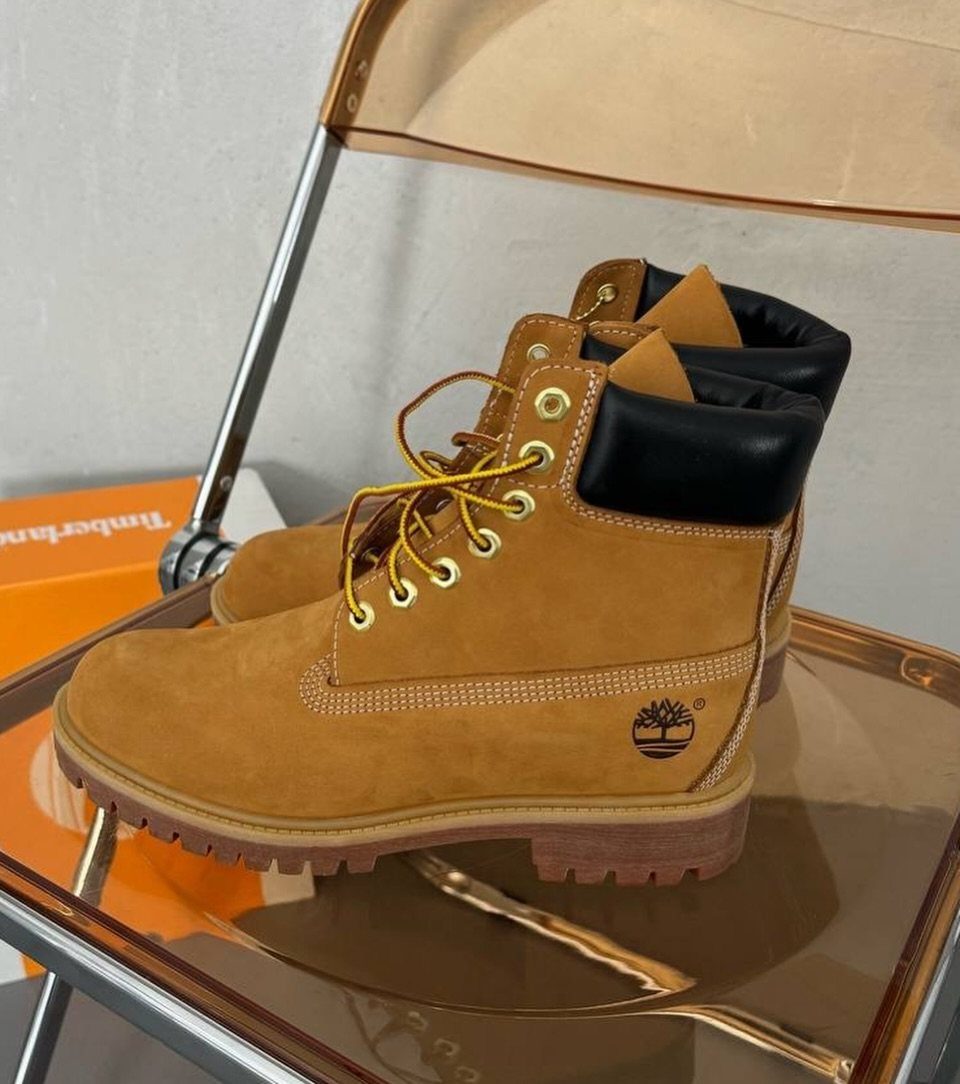 12 Useful Gifts for Dad: Practical Picks He'll Actually Use 9 Tan leather work boots with yellow laces on a clear acrylic shelf