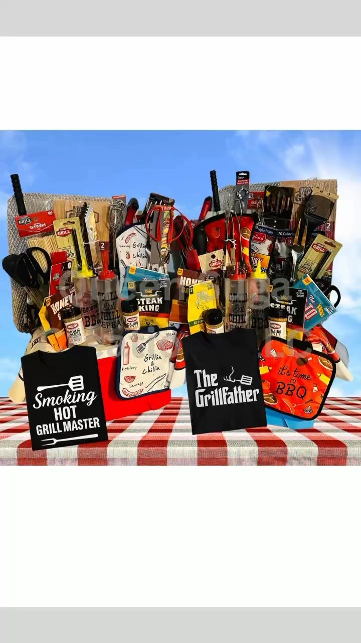 BBQ gift basket with grilling tools, sauces, and themed t-shirts on checkered tablecloth.