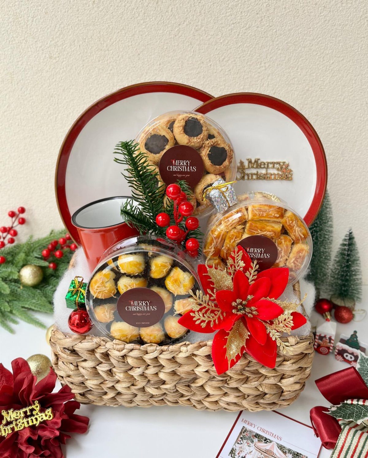 Woven gift basket filled with Christmas cookies, a red mug, and festive decorations.