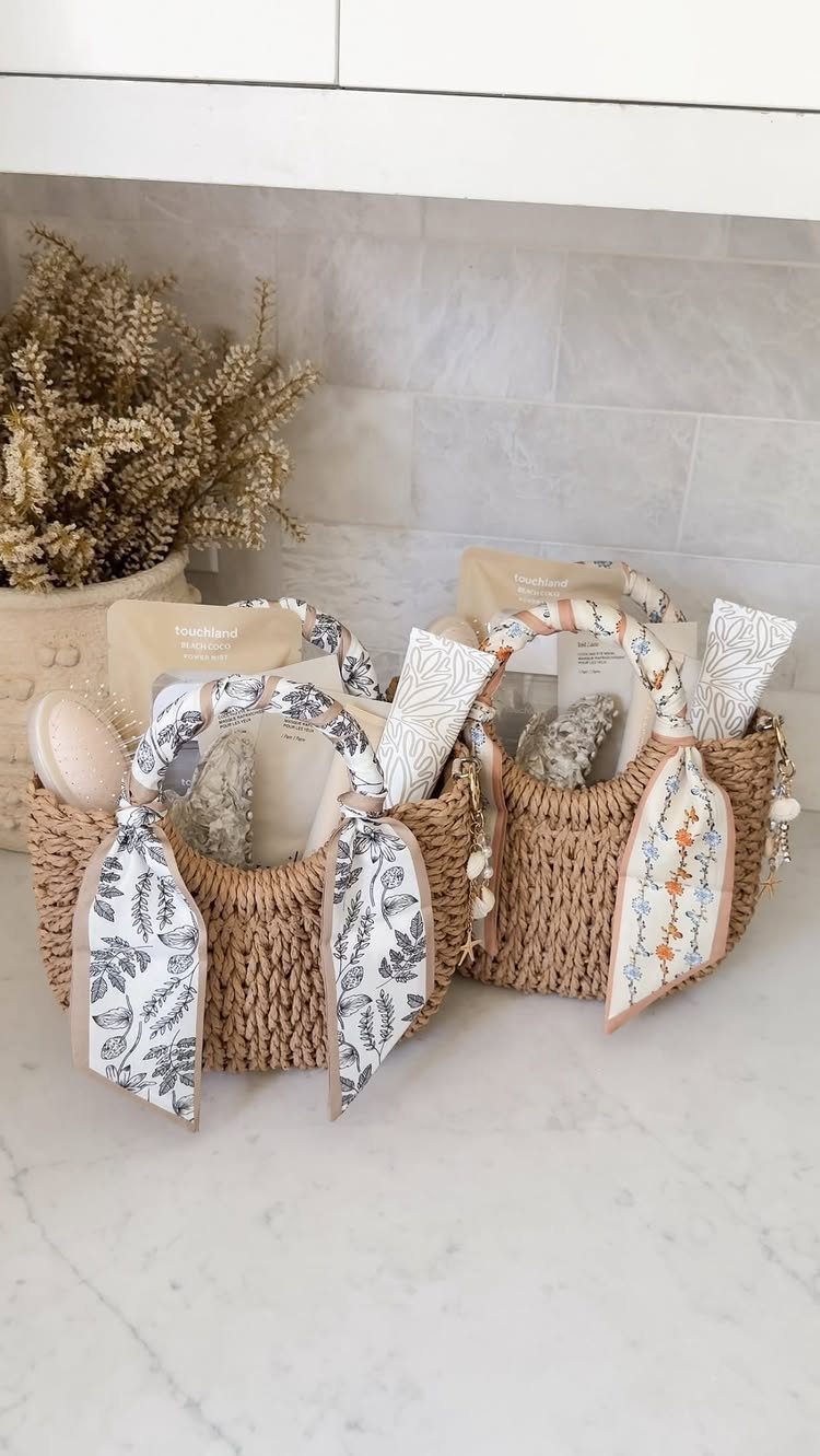 Woven straw gift baskets filled with skincare products and tied with patterned ribbons.
