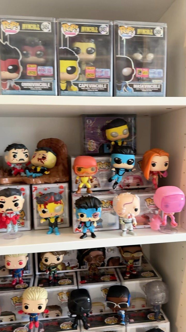 Funko Pop! collectible figures displayed both in boxes and out on white shelves.